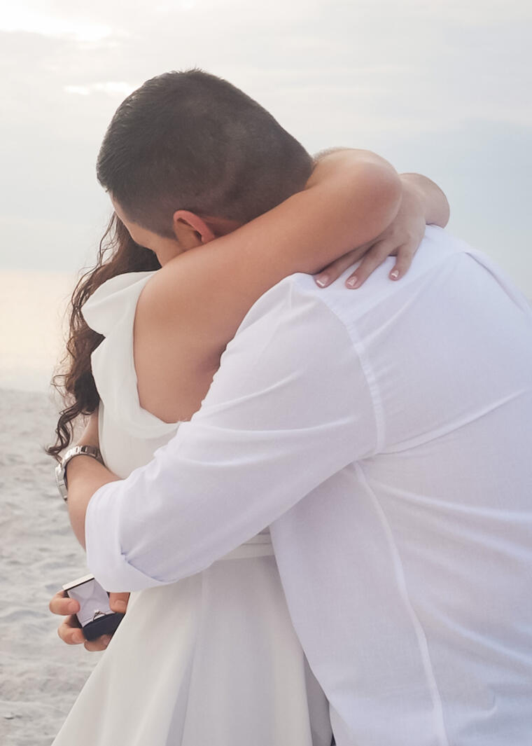 Man and woman embracing after marriage proposal
